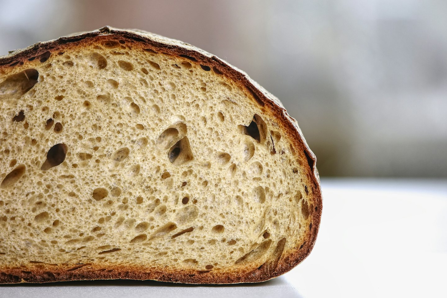 Sourdough bread slice showing a crusty exterior and airy crumb.